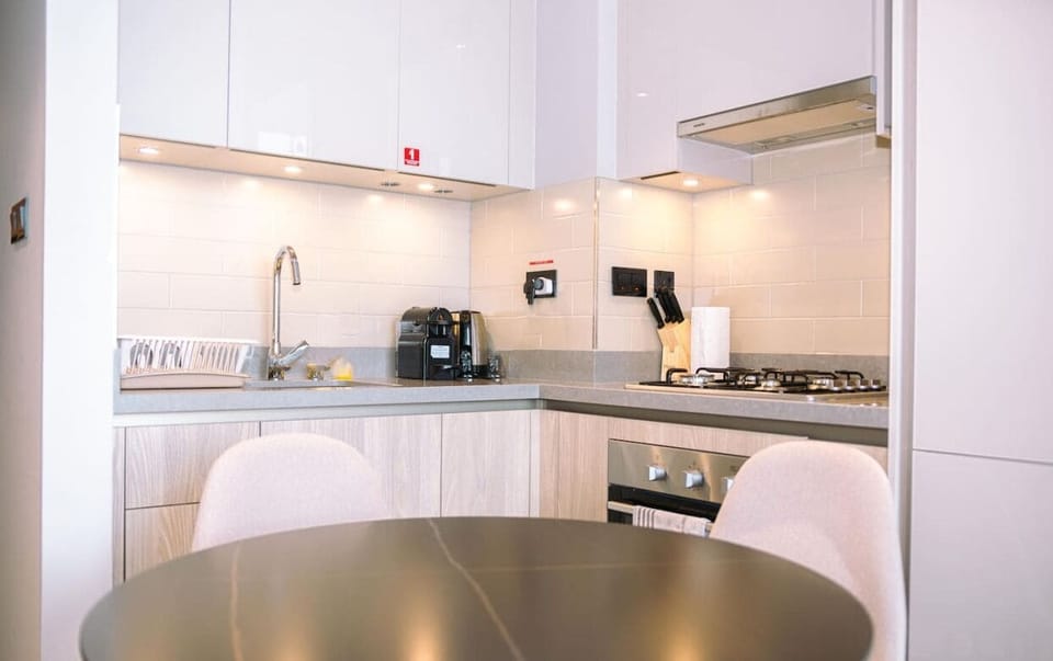 Adjacent to the kitchen, a small, round dining table sits perfectly for enjoying meals or doubling as a workspace.
