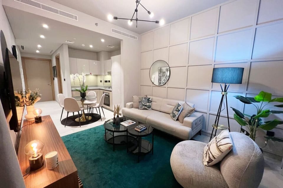 A furnished living room with Open-fitted kitchen and dining table for your convenience.