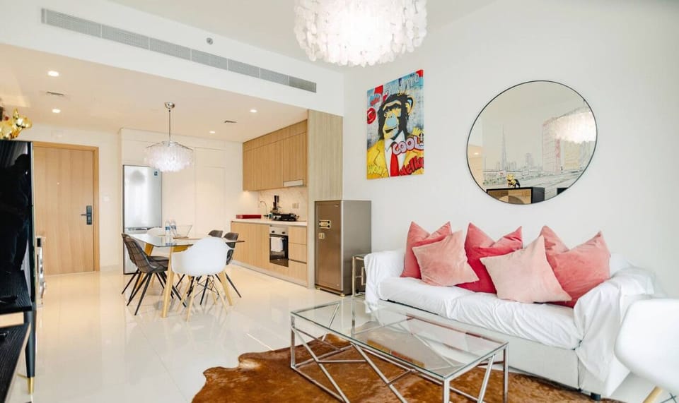 A sleek, open-plan dining and living area with minimalist decor and plenty of natural light.