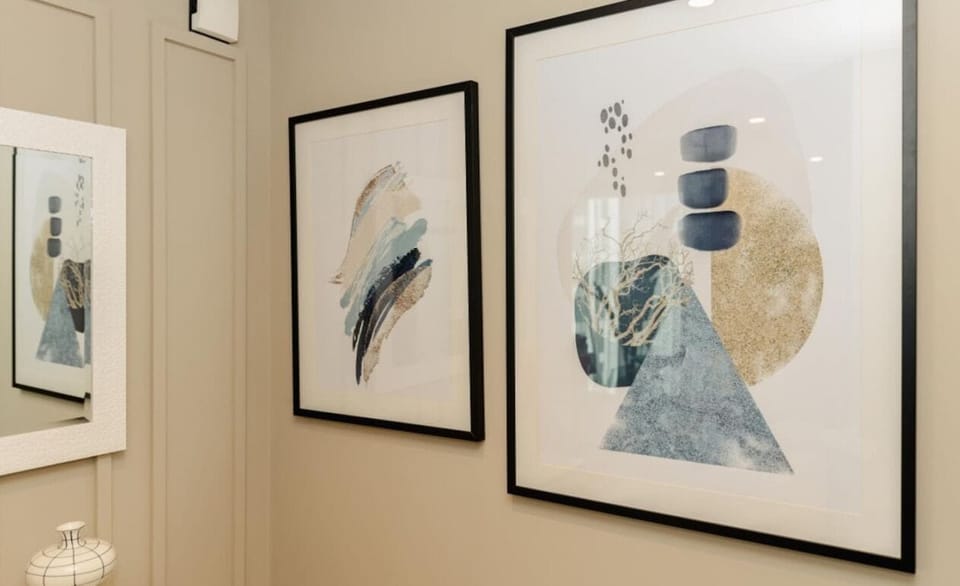 Modern artwork adds a touch of sophistication to the living space, creating a chic and relaxing ambiance.
