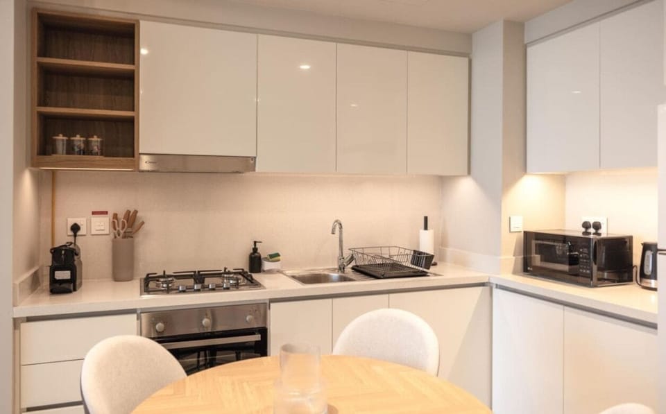 Adjacent to the kitchen, a stylish dining table provides a perfect setting for enjoying meals and gatherings.