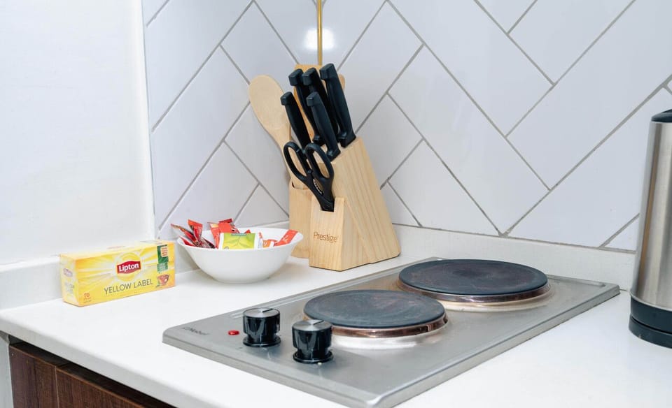 Spacious and stylish kitchen, fully equipped with cookware, utensils, and modern appliances for a seamless cooking experience.