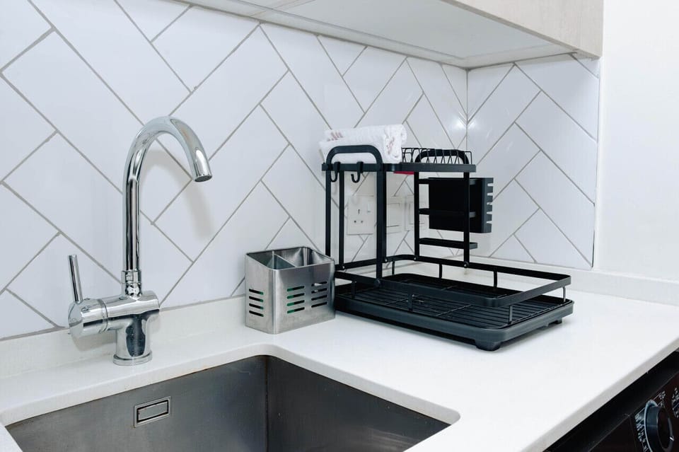 Spacious kitchen sink with sleek fixtures, making cleanup easy and efficient.