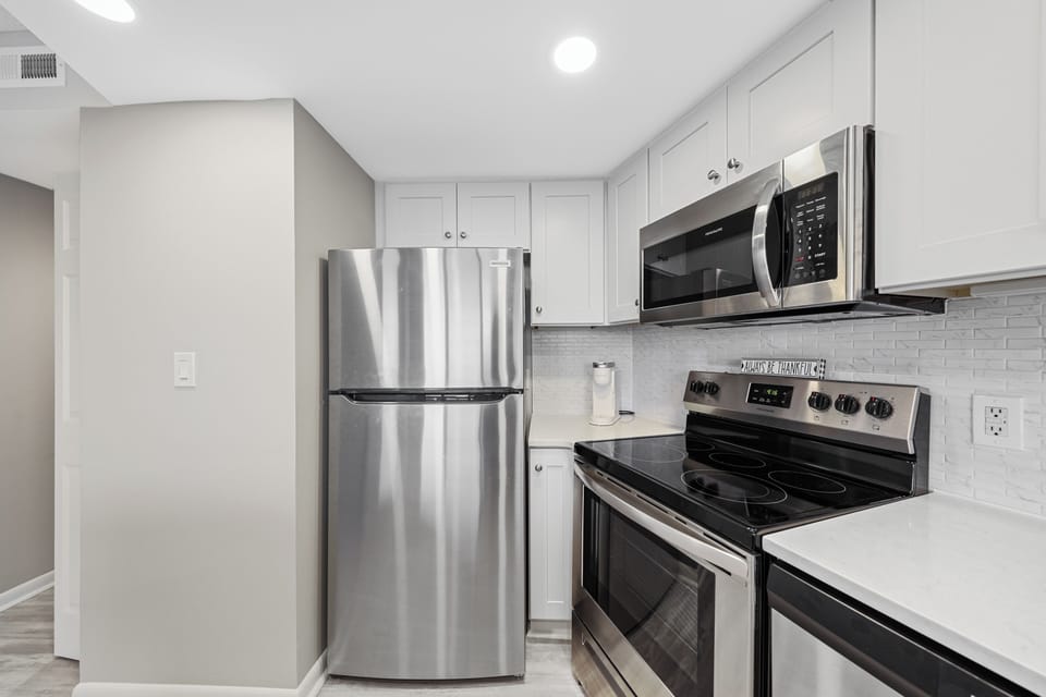 The wonderful kitchen features new stainless steel appliances.