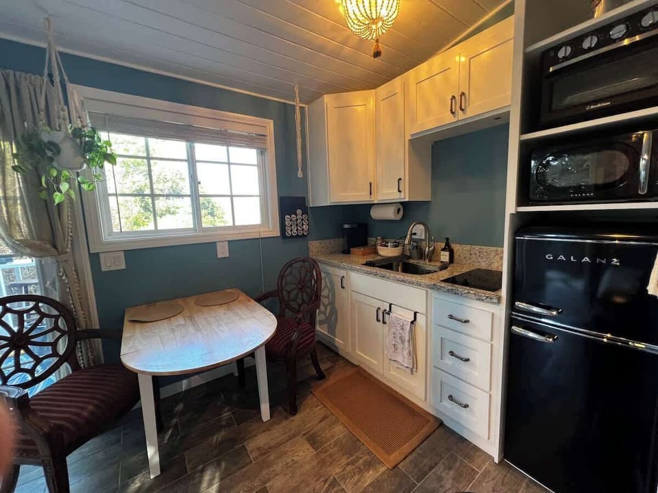 Kitchenette has a mini-fridge, microwave, toaster over/air fryer combo, 2 plate induction burner, sink, Keurig coffee machine, and all the basic utensils and pots/pans you'll need.