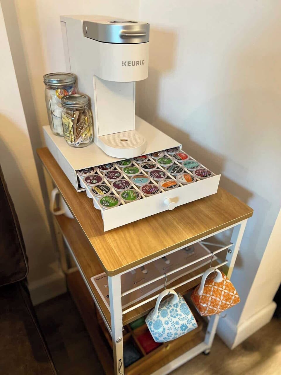 The Zen Den: Coffee and tea station with Keurig hot and ice coffee maker, pods, sugar, and creamer.