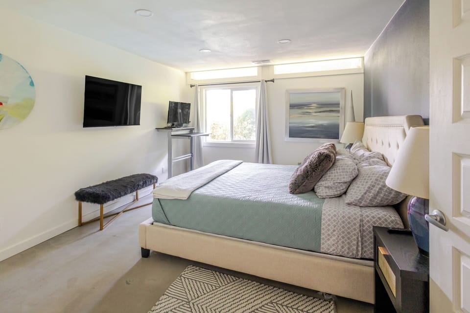 Primary bedroom with king bed and TV on the main floor. 