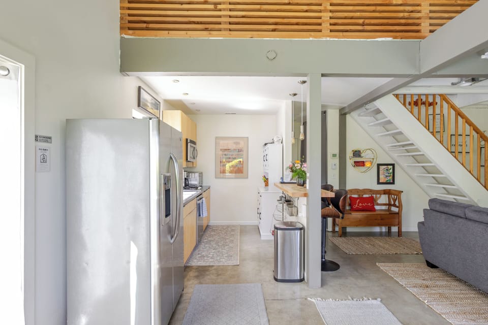 Kitchen with breakfast bar.  Stairs lead to the loft. 