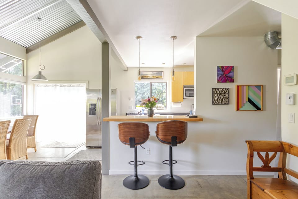 Breakfast bar with dining area to the left.  The glass doors open to the patio. 