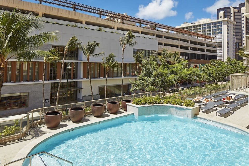 Bask in tropical sunshine with skyline views beyond the pool.