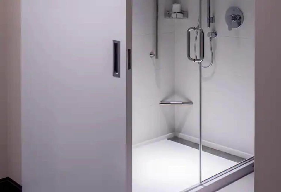 Rinse off in a sleek glass shower with modern fixtures.