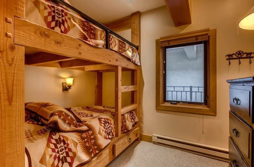 The bunk room, designed for fun and relaxation, combines stylish decor with warm colors, making it an ideal haven for kids after an adventurous day outdoors.
