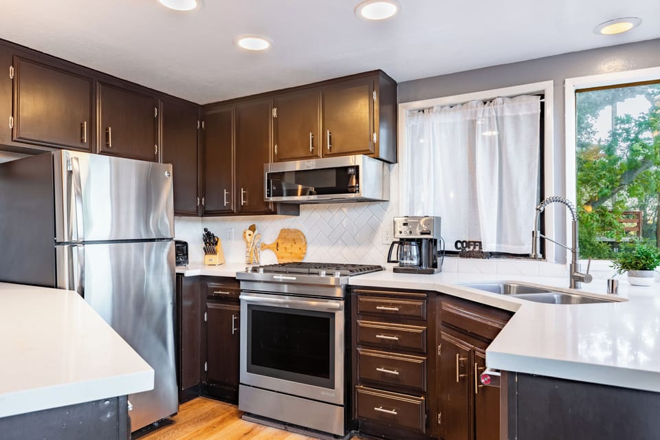 Fully equipped kitchen with stainless steel appliances.