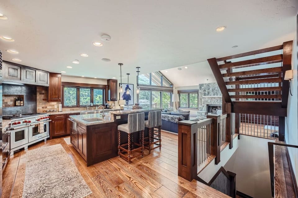 Experience luxury in an open kitchen concept featuring top-of-the-line Wolf gas stove, Sub-Zero fridge, and dual sinks for effortless meal prep. Perfectly designed for culinary enthusiasts and entertaining in style!