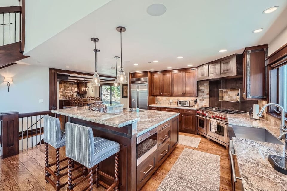Experience luxury in our Vail View house with an open kitchen concept featuring top-of-the-line Wolf gas stove, Sub-Zero fridge, and dual sinks for effortless meal prep. Perfectly designed for culinary enthusiasts and entertaining in style!