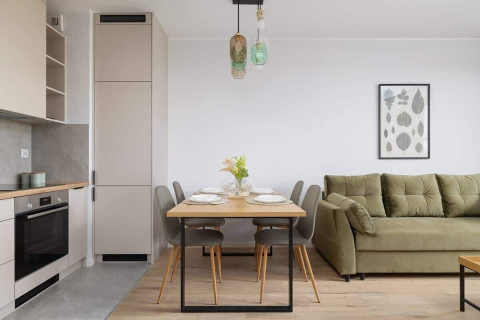 Chic and inviting living area with soft lighting and a fresh palette of green and beige tones.