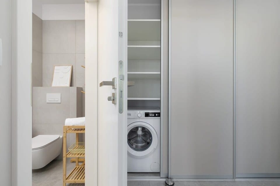 Well-organized bathroom-laundry combo offering both functionality and sleek, modern design.