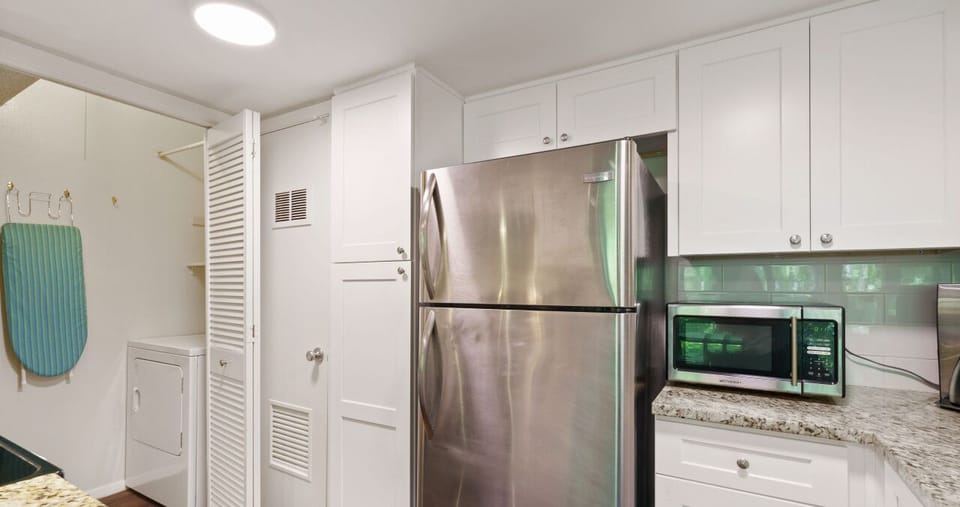 Full kitchen with all the essentials plus laundry room/ pantry