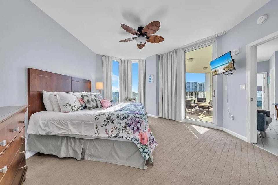 Master bedroom with king bed (sleeps 2), balcony access, and ensuite full bathroom