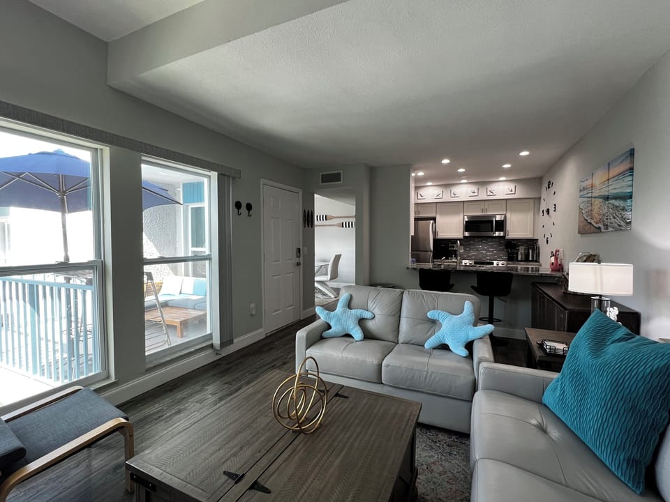 View of the comfortable living room looking towards the front en - View of the comfortable living room looking towards the front entrance door and open concept kitchen.