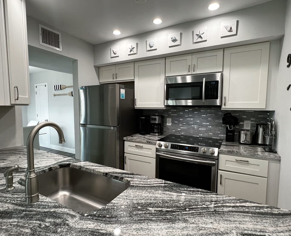 View of the beautifully renovated kitchen- fully stocked with an - View of the beautifully renovated kitchen- fully stocked with anything you could need while enjoying your trip!
