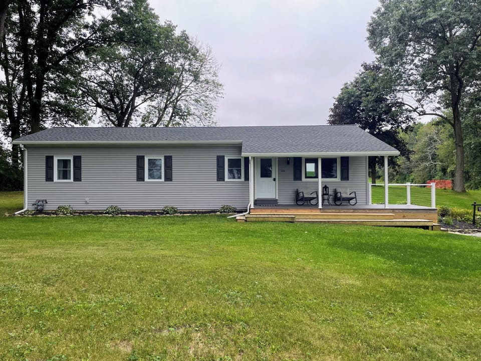 Front of house with covered and open front porch