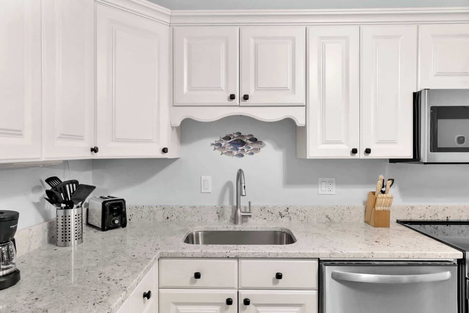 The bright, airy kitchen offers ample space & all the comforts of home