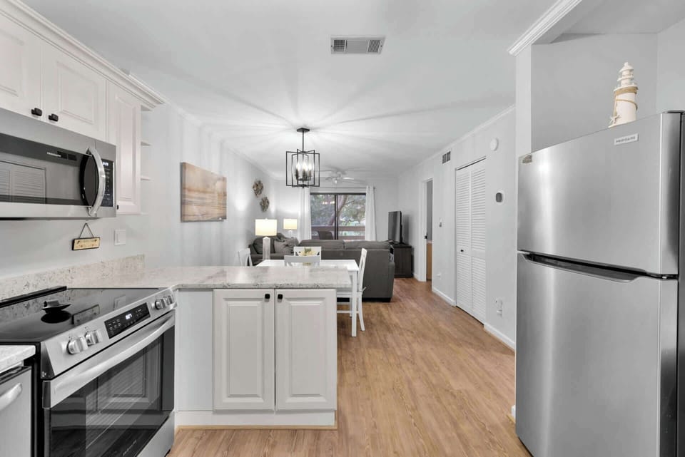 The bright, airy kitchen offers ample space & all the comforts of home