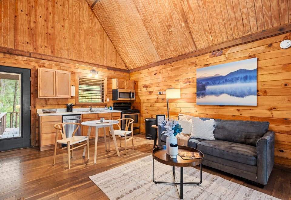 Another look at the inviting living and dining space—great for hanging out, sharing meals, or simply enjoying the cozy cabin vibe.