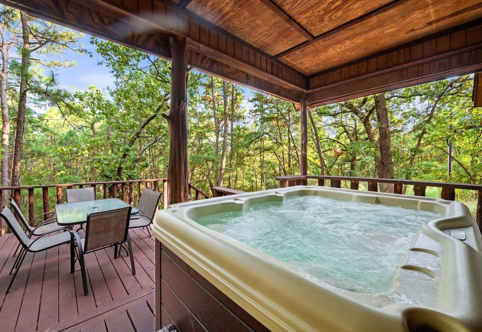 Unwind in the hot tub on the deck, surrounded by nature's tranquility—ideal for soaking under the stars after a day of adventure.