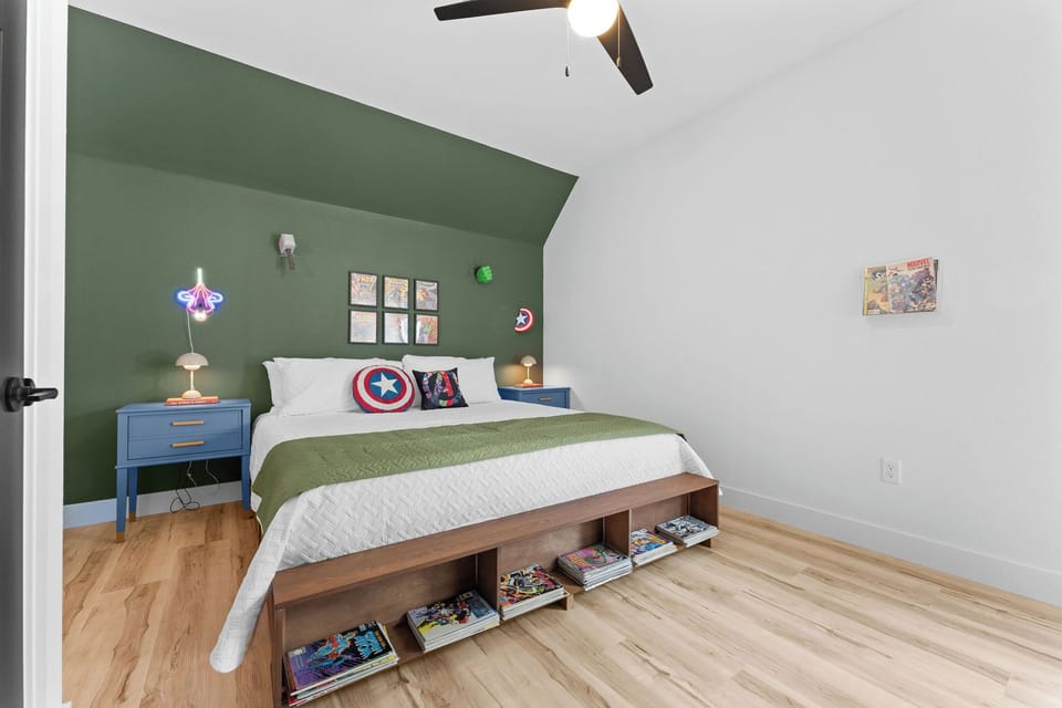 King bedroom with Marvel superhero theme, private ensuite, and comic book art accents.