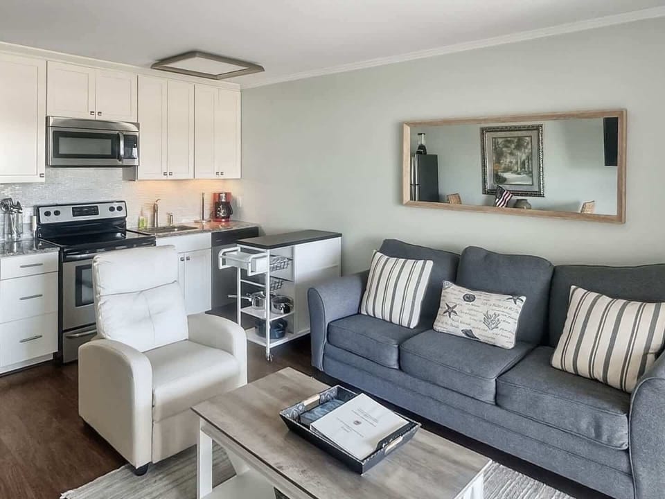 Open-concept living area featuring a comfortable charcoal-grey sofa.