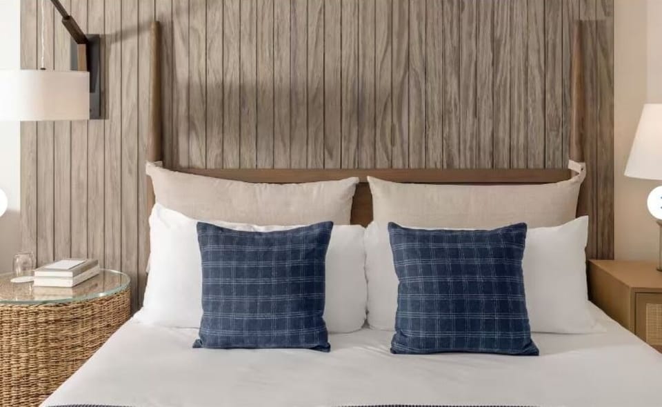 Sink into a plush, perfectly made bed for deep rest.