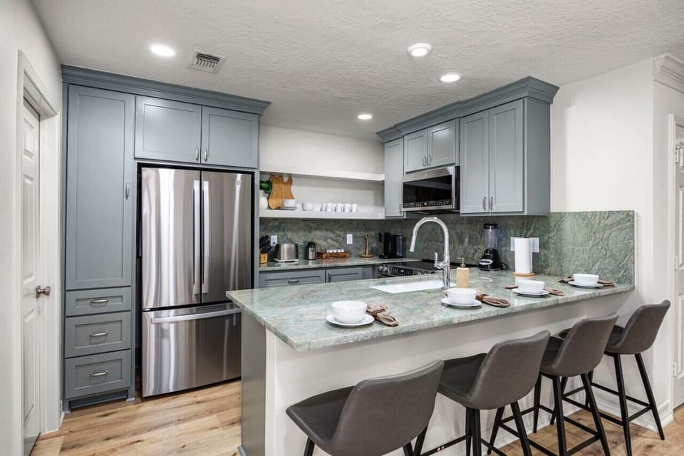 Fully remodeled kitchen with island seating and modern appliances