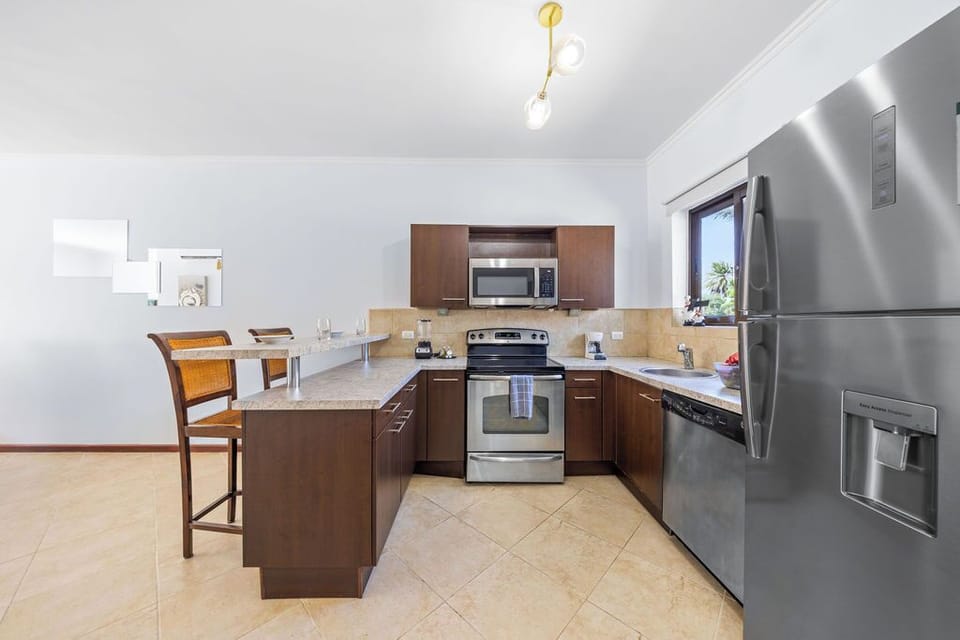 Cook in style in this modern kitchen with a functional island, top-of-the-line appliances, and plenty of space to create your favorite dishes.