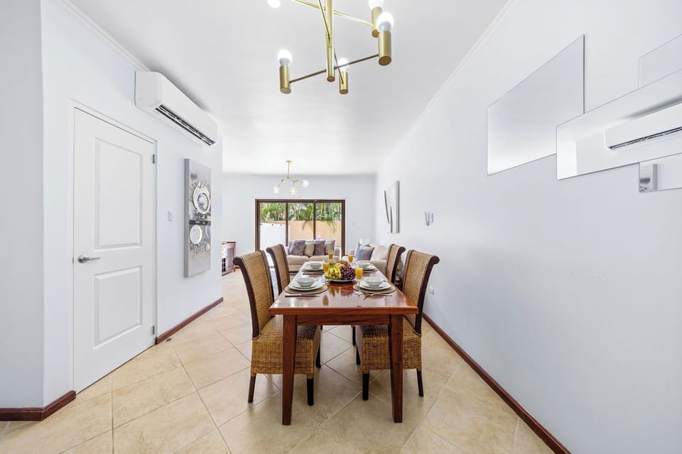 Elegant dining space featuring a table for four, seamlessly blending comfort and style for memorable meals.
