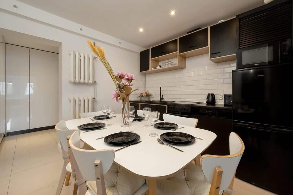 Kitchen area with dining table and chairs.
