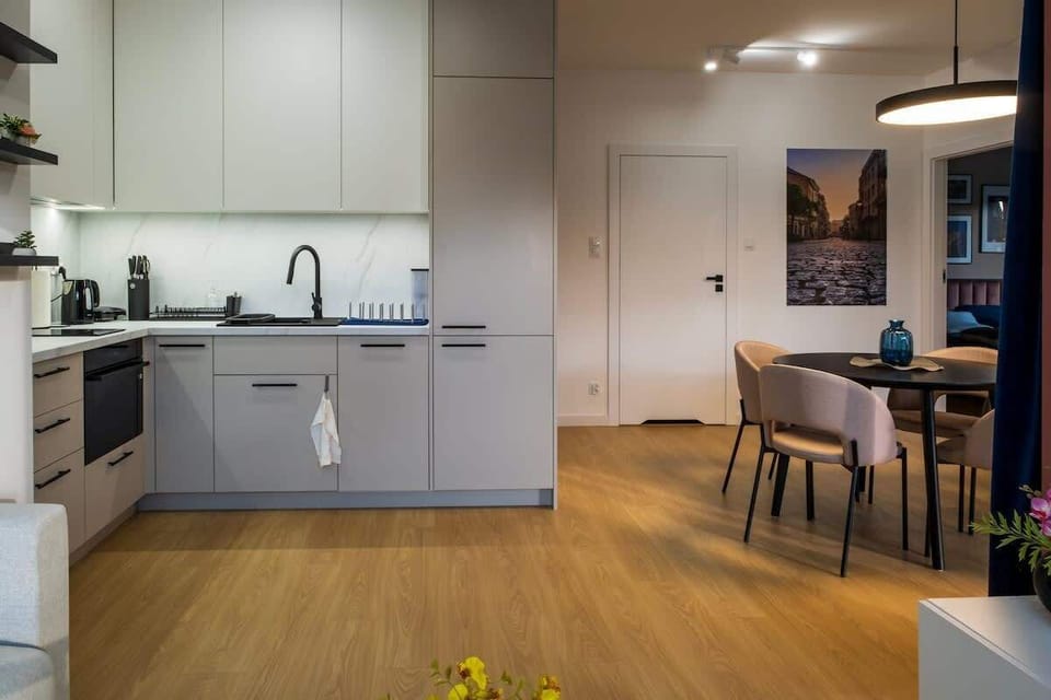 A stylish kitchenette in the open living room, with dining area and minimalist design.