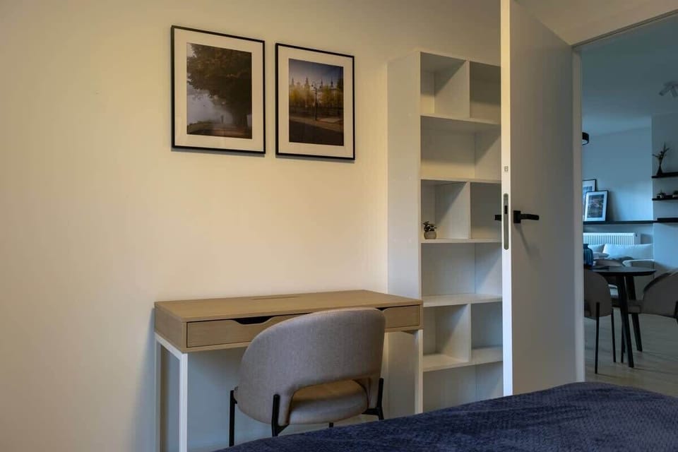  A bright workspace with a desk and shelving—perfect for studying or remote work in comfortable surroundings.