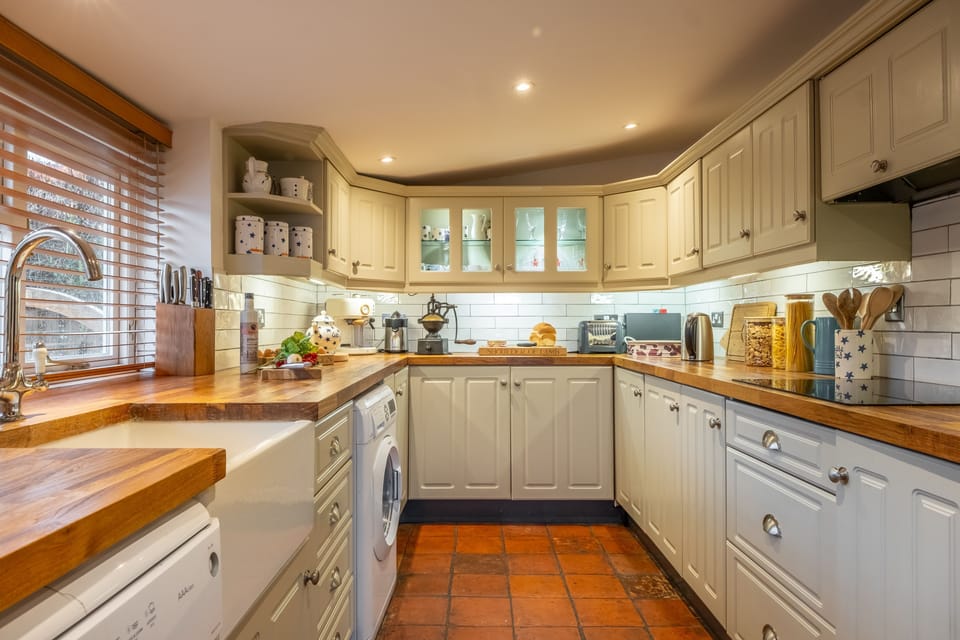Ground floor: Kitchen with electric double oven, electric hob, microwave, fridge/freezer, dishwasher, washing machine and coffee machine
