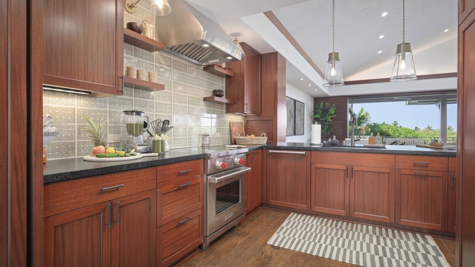 The spacious kitchen area features wide counter spaces for a breezy meal prepping.