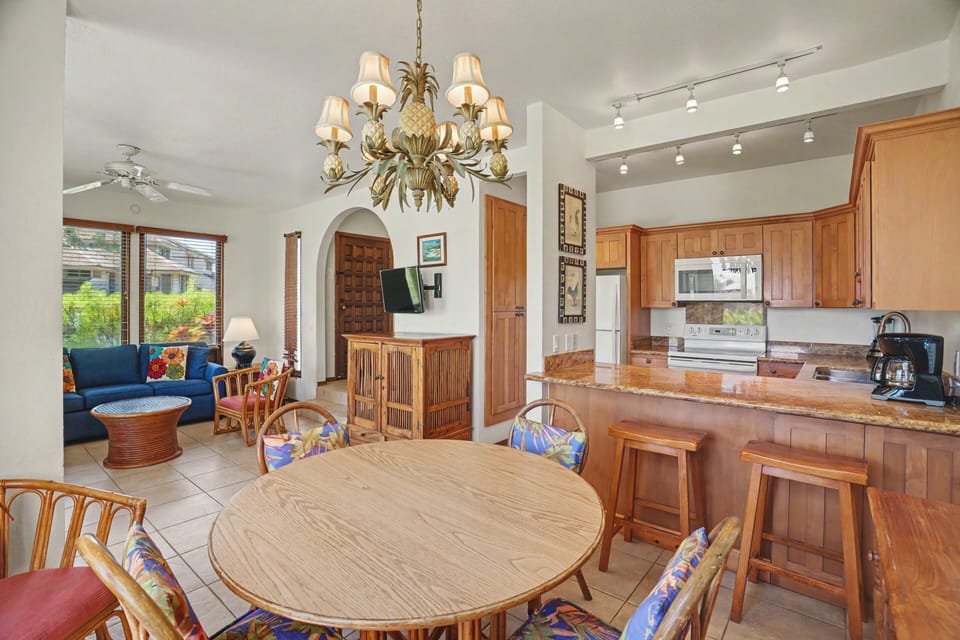 This open-concept space invites you to relax, cook, and gather with loved ones. Warm wood tones, tropical accents, and abundant natural light create a welcoming island retreat.