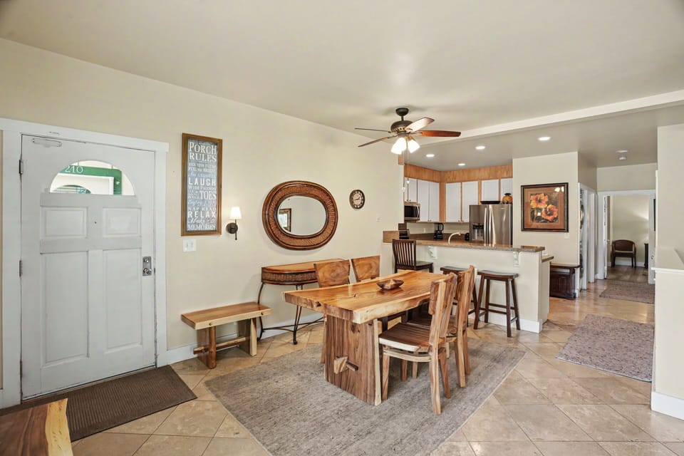 Step into your welcoming open-plan living space, where rustic charm meets comfort. Gather around the handcrafted wood dining table and enjoy meals together in this bright, inviting home.