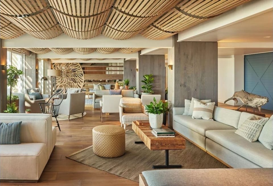 Gather comfortably under warm wood details in the coastal lounge