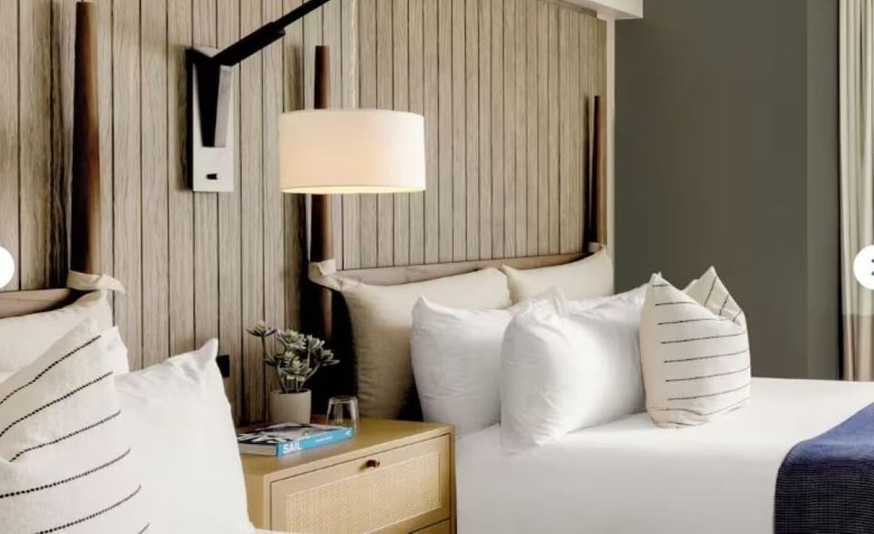 Sink into pillowy bedding and soft bedside glow.