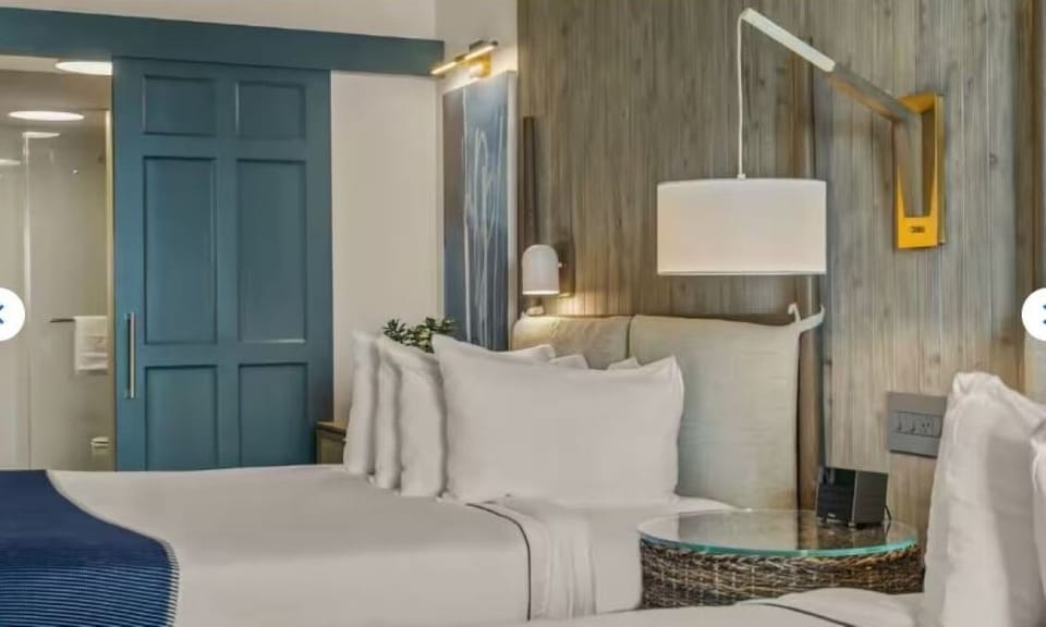 Drift off in a serene space framed by ocean-blue accents.