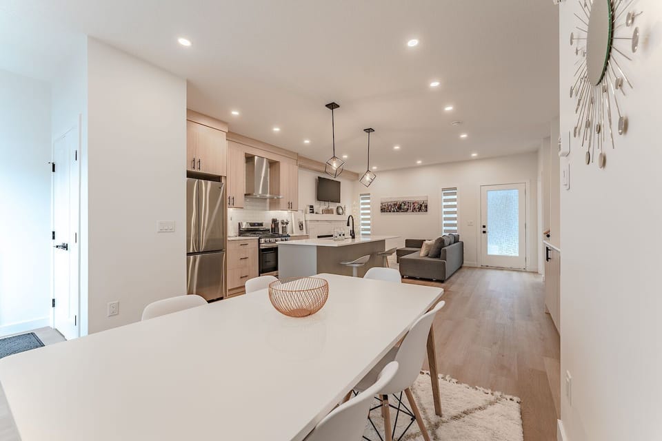 Open-concept kitchen with XL island, flowing to dining and living room