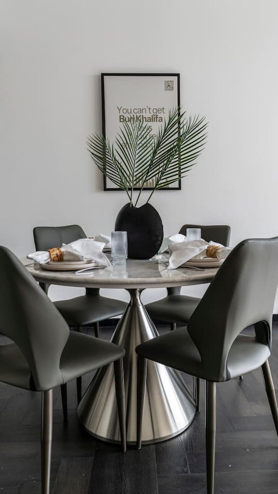 Elegant dining setup with plates, cutleries and stylish wall decor