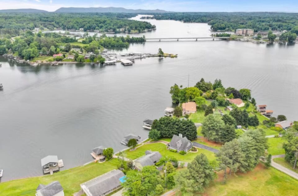 Generous, well-manicured grounds flowing seamlessly into the lake, featuring a private dock for easy access to water adventures.