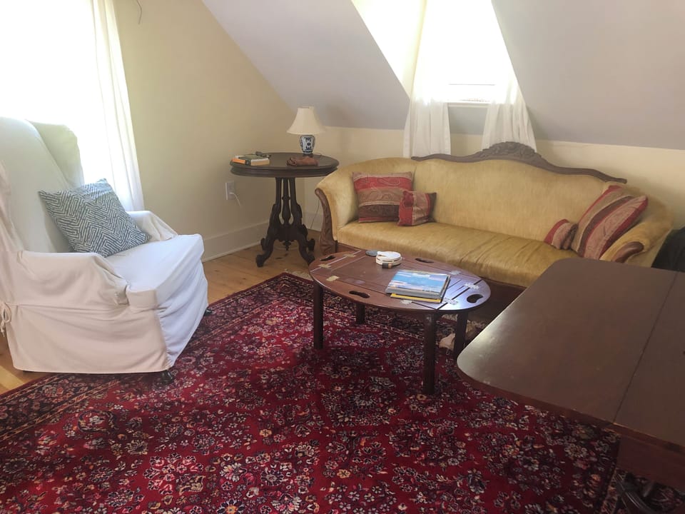 Sitting area with couch. Dining table can be used for meals or desk.